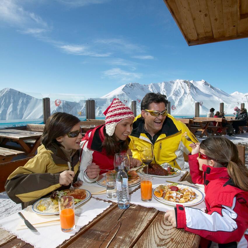 family skiing holiday tyrol eating traditional hut skiing area