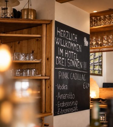 Begrüßungstafel an der Bar mit handgeschriebener Cocktailkarte