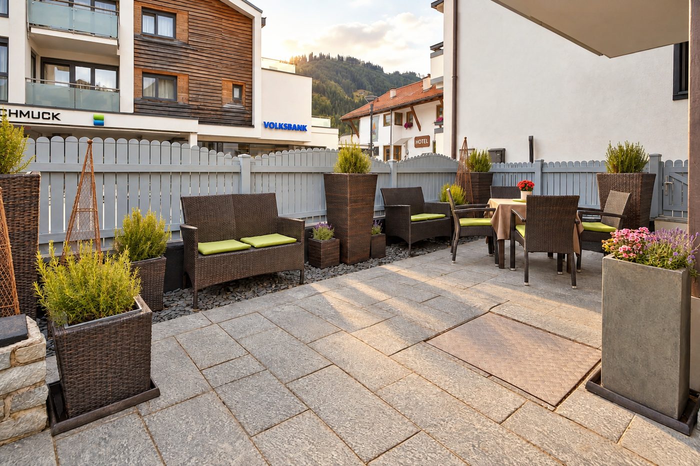 Terrace with lounge furniture, dining table and planters in Apartment Anneliese at Hotel DreiSonnen in Serfaus