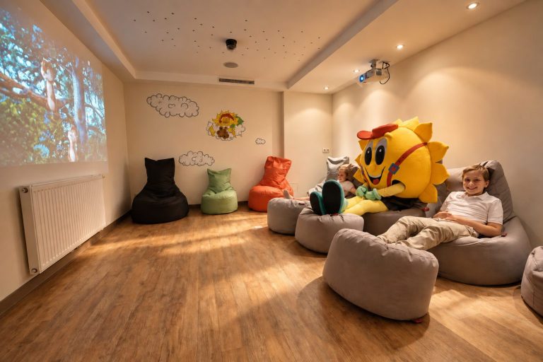 Children's cinema with screen, beanbags and mascot Sonni at Hotel DreiSonnen in Serfaus