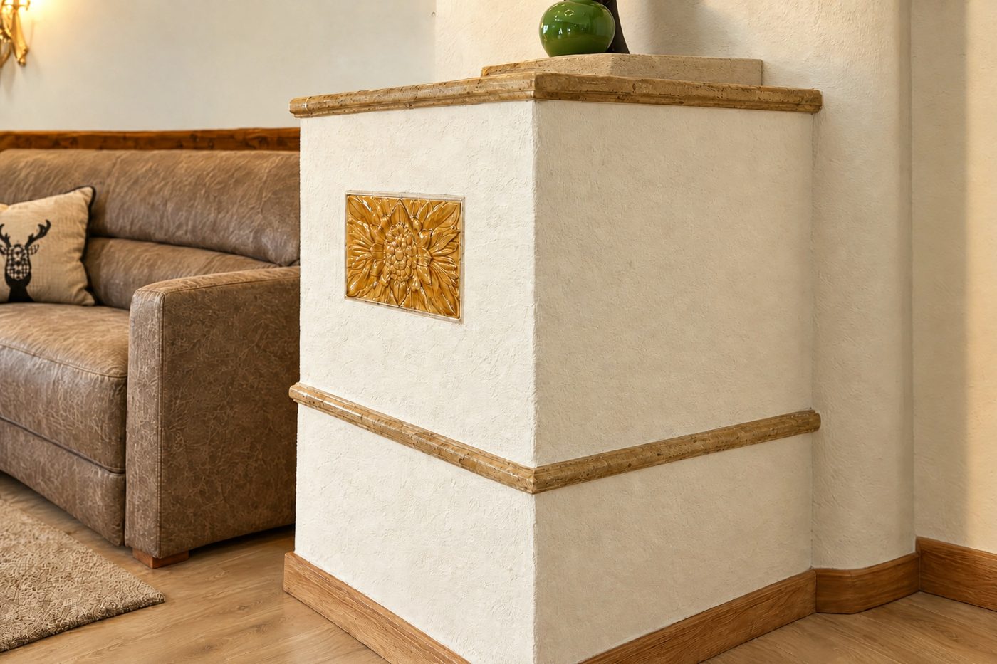 Tiled stove with an edelweiss tile beside the sofa in the Valentina room at Hotel DreiSonnen in Serfaus